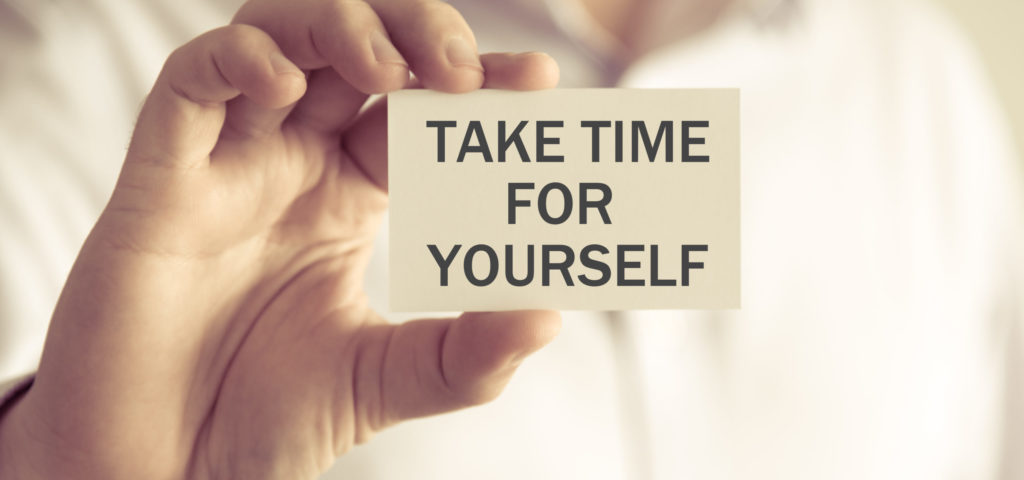 Businessman holding Take time for yourself message card